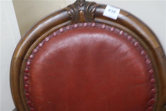 A Victorian red leather elbow chair